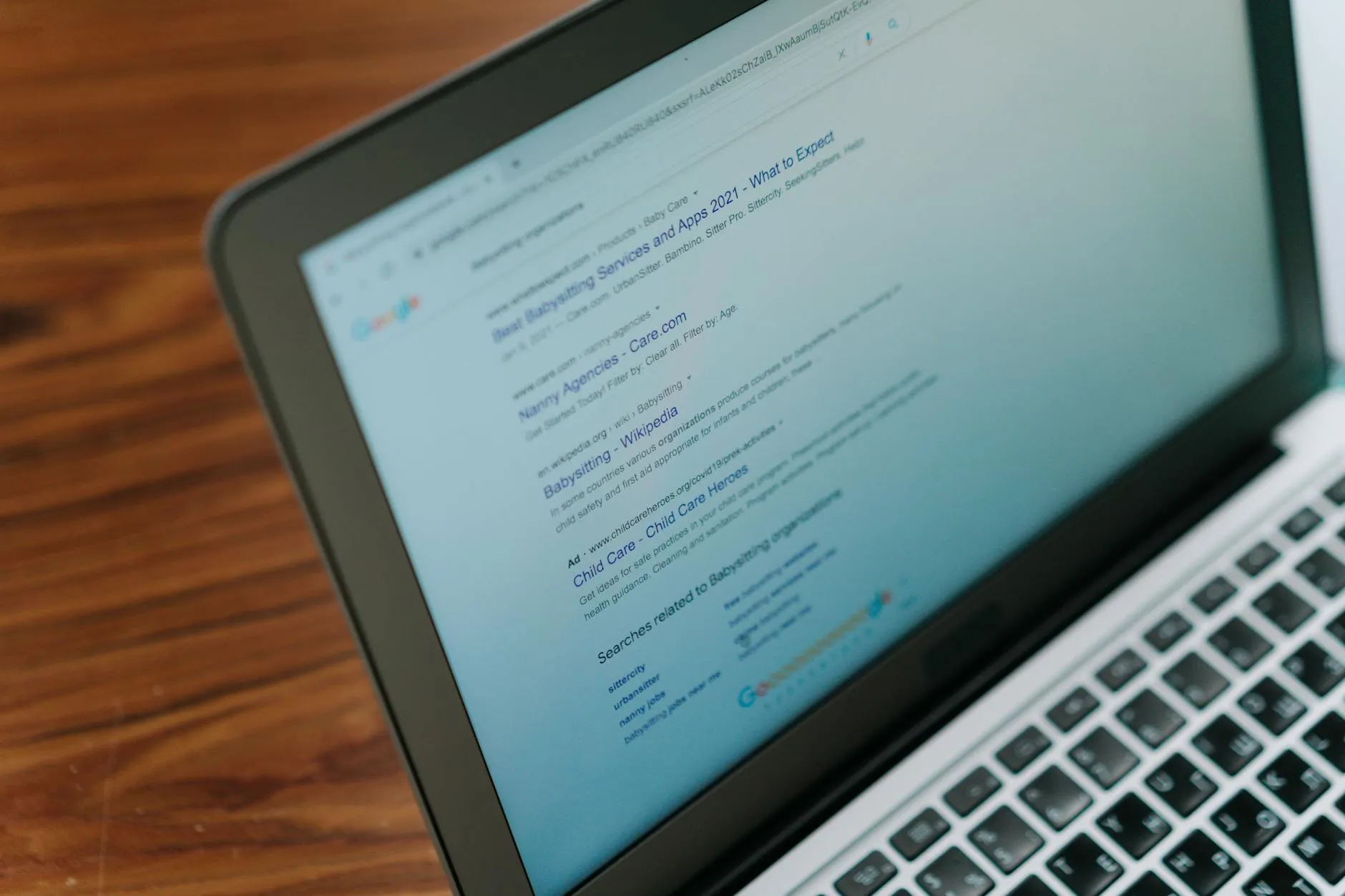 A close-up view of a laptop displaying a Google search engine results page