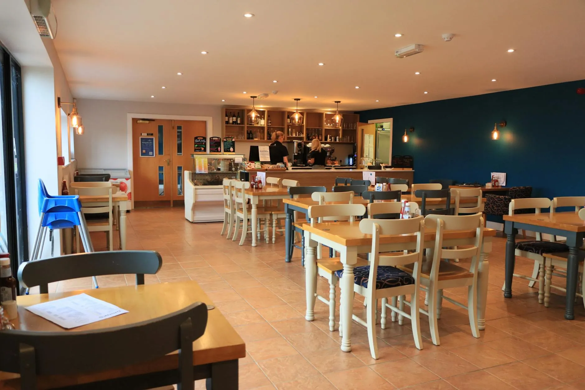 A cozy and modern café interior with wooden tables and bright lighting