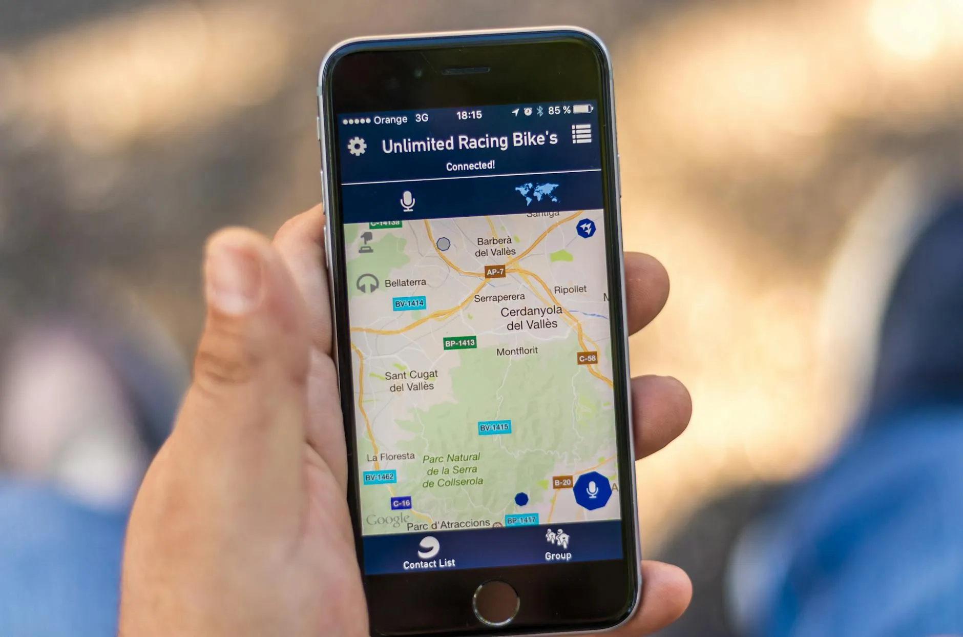 Hand holding a smartphone displaying a maps app with location data